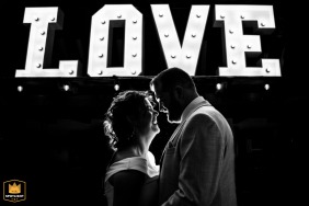 De Willemshoeve, Woerden, provides the backdrop as the newlyweds pose dramatically beneath a huge, illuminated marquee sign spelling out the word LOVE.